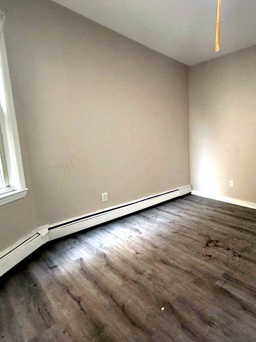 Second bedroom and wood-style flooring in Unit 2R