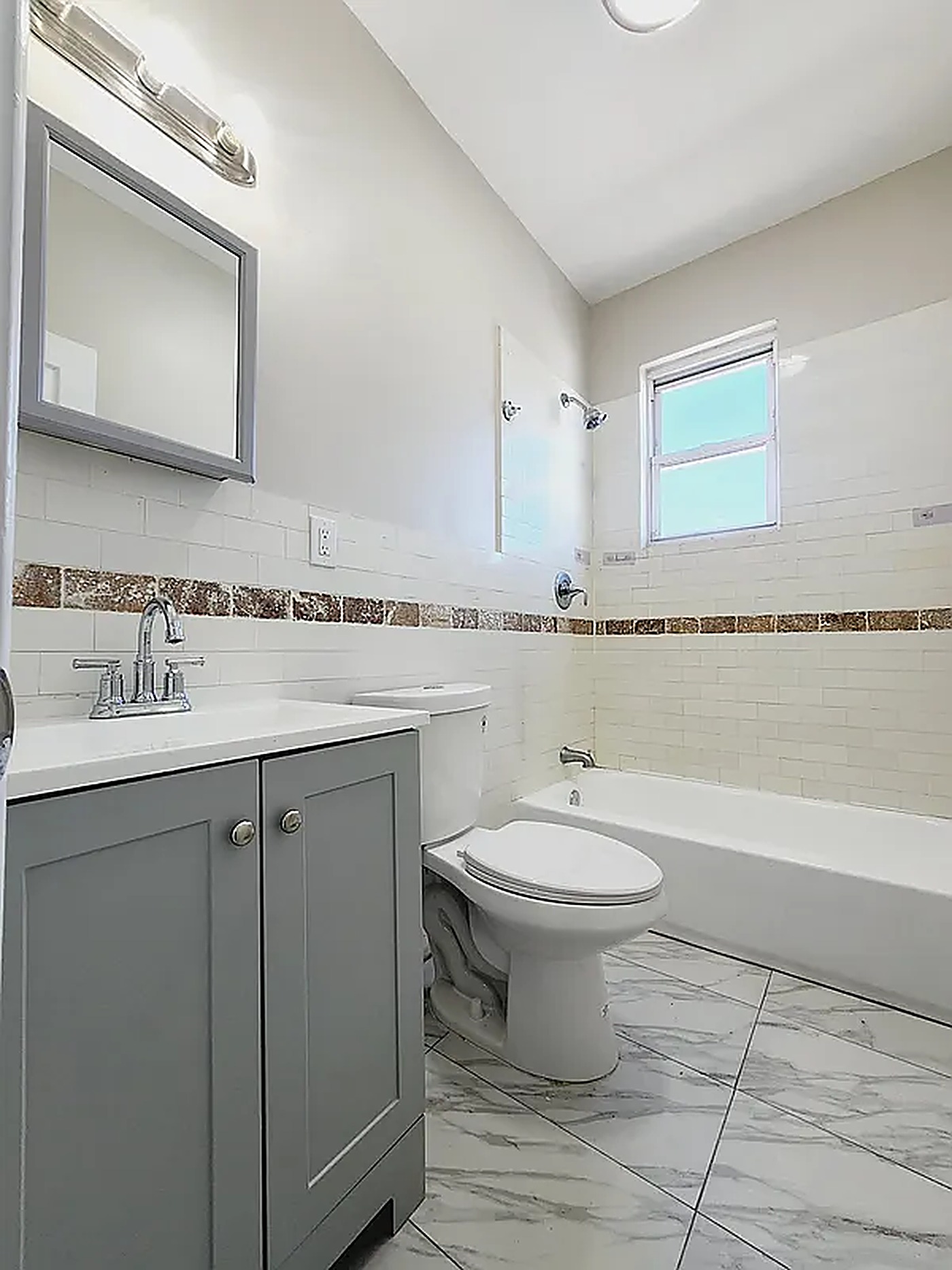 Renovated bathroom with tiled tub surround