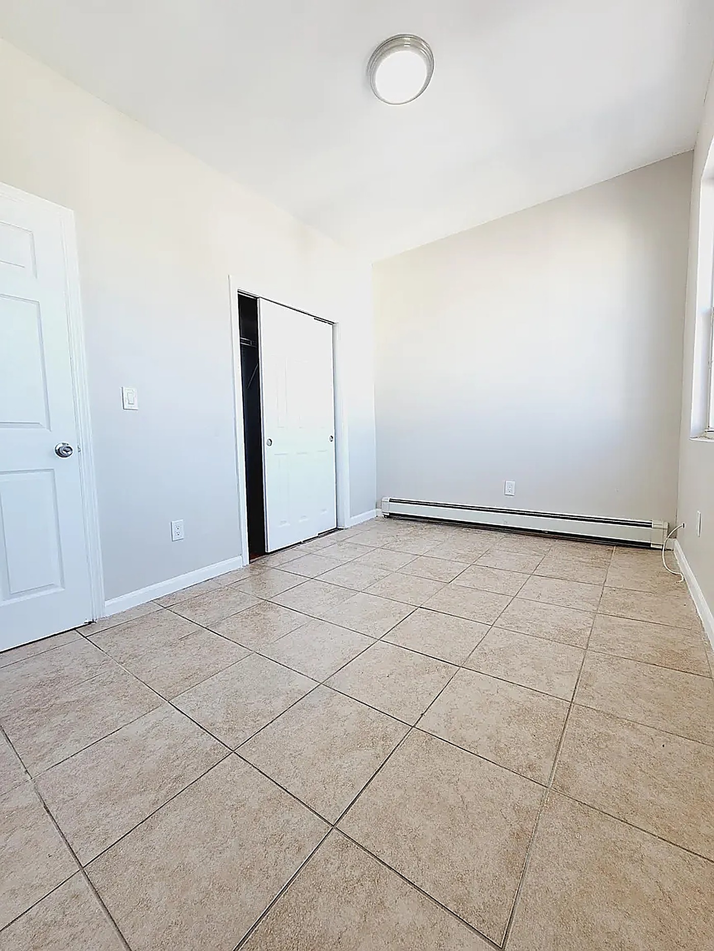 Bedroom with tile flooring
