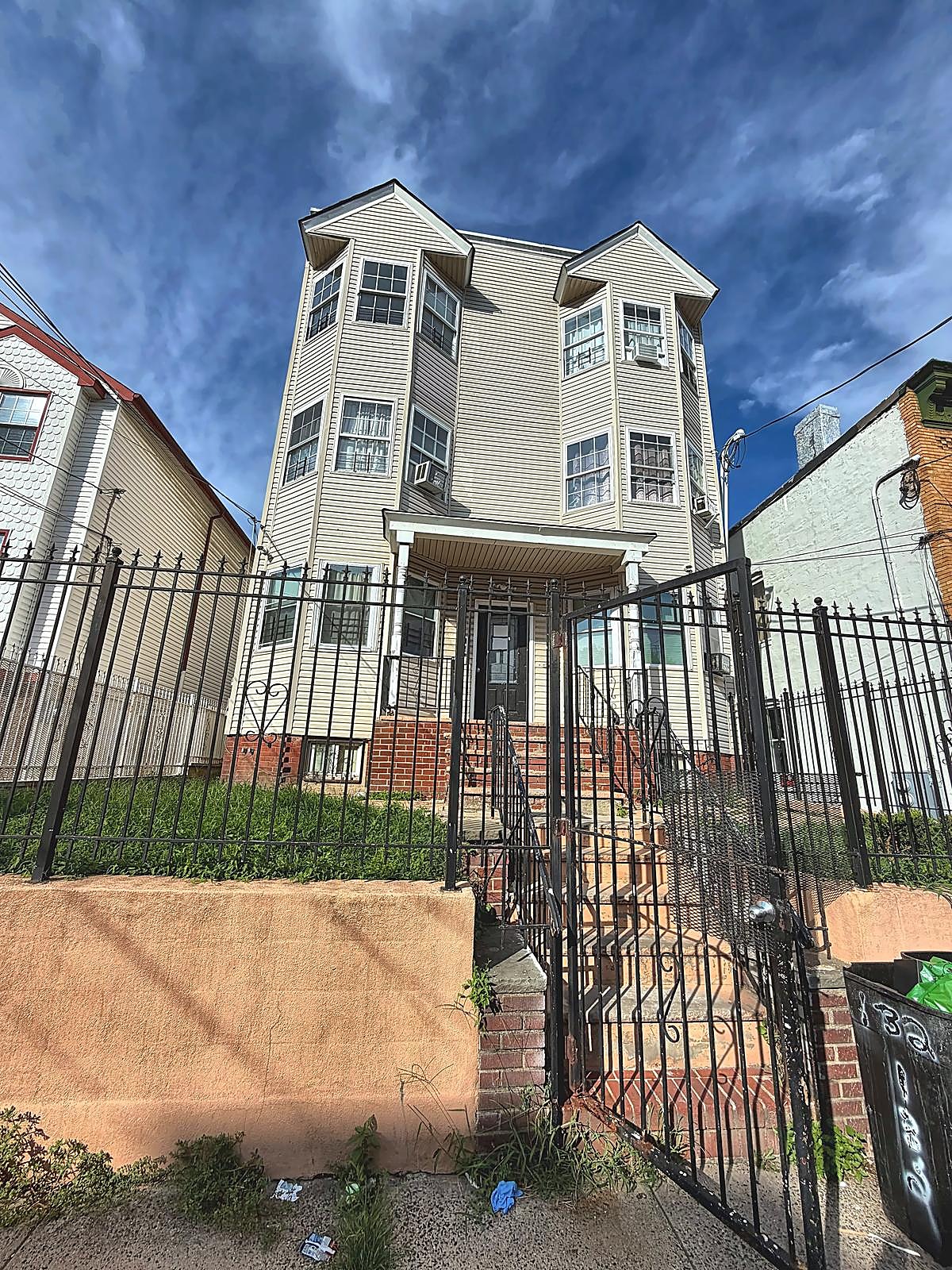 Gated front entry of 132 Wilkinson Ave
