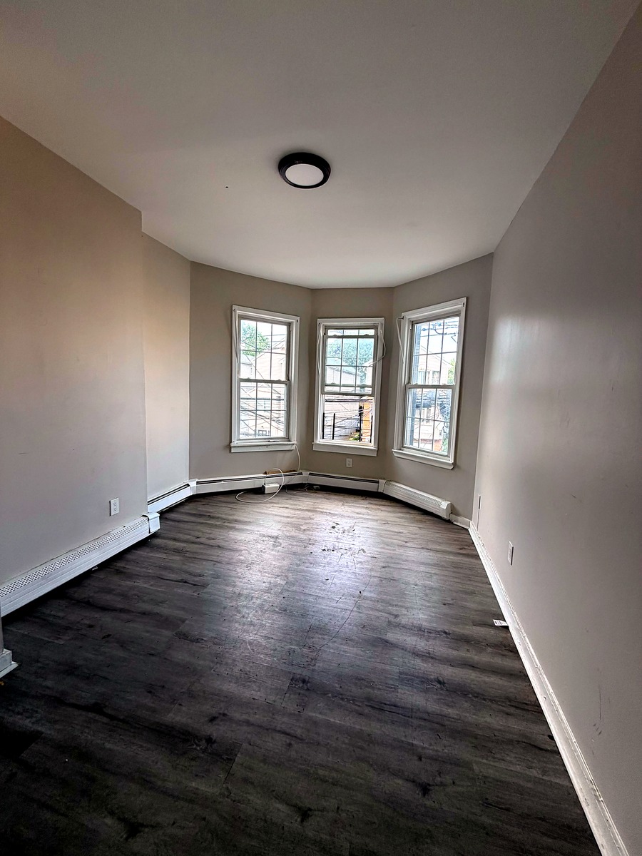 Bright living room with bay window in Unit 2R